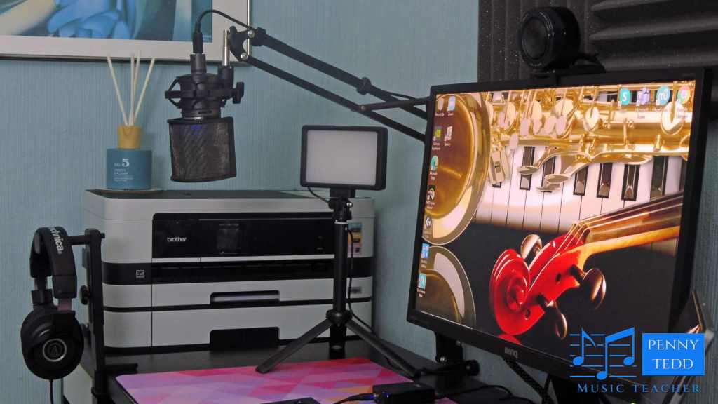 Close up webcam, microphone, headphones for online teacher of piano, cello, trumpet.